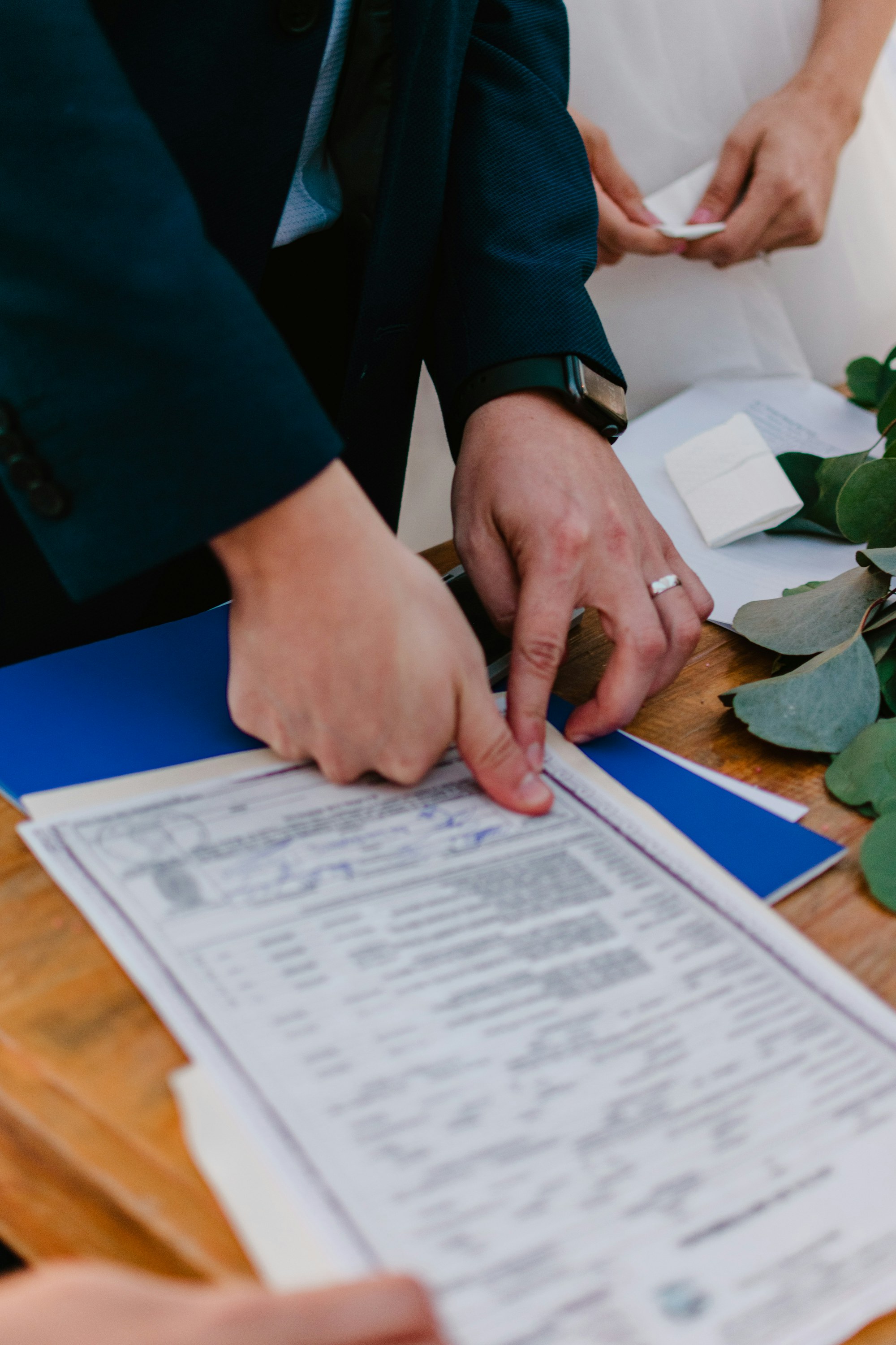 Couple signing their marriage certificate